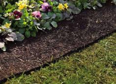 
                    
                        Clever idea to keep garden beds weed free. Also keeps the mulch from becoming ragged and falling into the lawn. Looks real but it's an artificial mulch border
                    
                