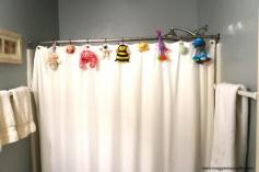 Hang small toys from shower curtain for a fun bathroom. www.maggiemaysgif...