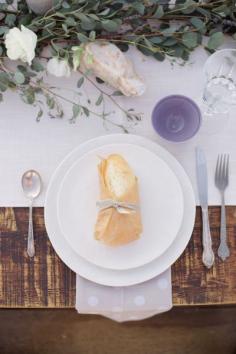 Simple and sophisticated table setting. Love the eucalyptus with the lavender cup.   Photography: Something Gold Photography - somethinggoldphot...