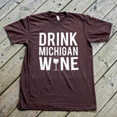 Michigan is home to over 15,000 acres of vineyards and 101 commercial wineries, which produce over 1 million gallons of wine each year! Show your support for all of our grape growing friends with this fresh "Drink Michigan Wine" tee! Also available in ladies sizes!    Color: Truffle   Art: White Water-Based/Discharge    -100% Ring Spun Cotton - American Apparel Fashion Fit Tees (Unisex)   -MADE IN THE USA, DESIGNED AND PRINTED IN MICHIGAN!