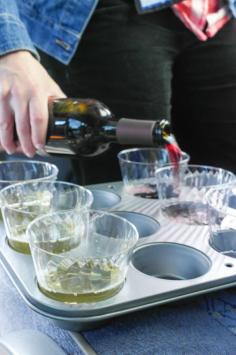 Cupcake pan + cups = portable wine party!  This would also be genius for tailgating events too.