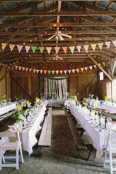 barn reception, photo by Sara Wilde ruffledblog.com/... #weddingideas #barnwedding #bunting