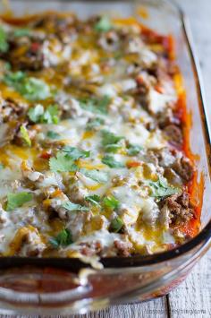 Taco Casserole - Biscuits are coated in taco sauce then topped with spiced ground beef and lots of cheese in this family friendly dinner idea.