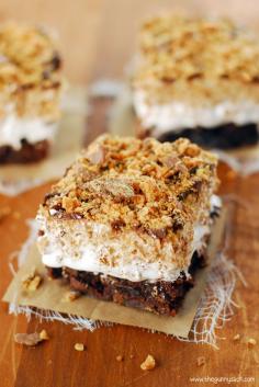 Butterfinger Ooey Gooey Bars with brownie crust, Butterfinger Rice Krispies Treats on top and marshmallow cream sandwiched between!