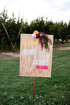 wooden sign with bright colors, photo by Love Katie + Sarah ruffledblog.com/... #weddingideas #weddingsigns