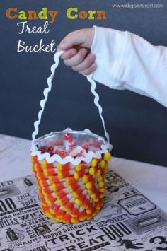 Make this super cute treat bucket out of a plain metal bucket and candy corn! #31DaysofHalloween