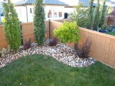 Dress up the corner of your yard with small trees/shrubs.