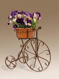 Fancy bike planter     Natural patina powder-coated finish     Holds 10-inch pot     Measures 15-inch diameter by 21-inch height     Measures 32-inch length by 33-inch height by 19-inch depth