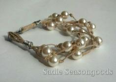 Those thrift store pearls never looked so good! A stuffy strand of thrifted pearls can be artfully re-imagined into chic, boho jewelry using hemp twine or leather cord. Awesome tutorial for a great repurpose project! #sadieseasongoods