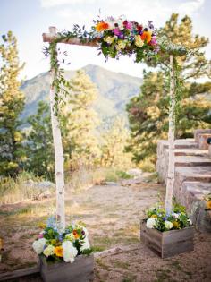 This simple, rustic ceremony arch perfectly complements a gorgeous natural backdrop.