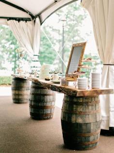 Table at the reception made out of wine barrels. Perfect for a winery wedding, or even a rustic wedding too!