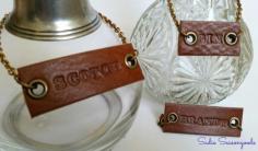 DIY liquor / decanter tags made from stamped leather belts...all from thrift stores! These are so cool- would make a perfect gift for him, and really add something special to your home bar. #sadieseasongoods