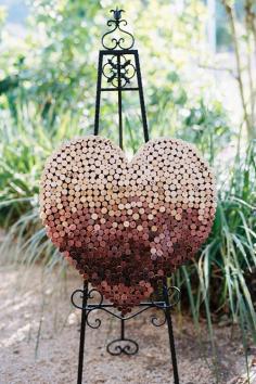 
                    
                        A wine cork heart is a great centerpiece for a vineyard ceremony | Photography by Leah | Brides.com
                    
                