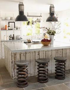 
                    
                        An airy kitchen in a Napa cottage filled with reclaimed items including galvanized metal counter tops and vintage truck springs used as stools.
                    
                