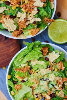 
                    
                        This BBQ chicken salad starts with a base of romaine, is topped with lightly salted corn and black beans, shredded chicken that's been cooking all day in the crockpot, a few crushed tortilla chips, and a Ranch yogurt dressing! Healthy, filling, and delicious! showmetheyummy.com #healthy #salad #bbq #crockpot #chicken
                    
                
