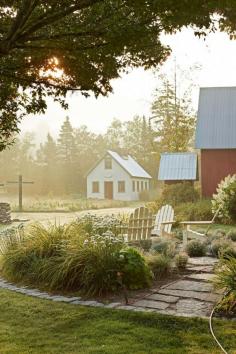 
                    
                        Lobelia, daylilies, nasturtium, and garlic chives surround L.L. Bean Adirondack chairs on the patio, located between the house and the main red barn. Tarr constructed the white field barn to store his tools.   - CountryLiving.com
                    
                