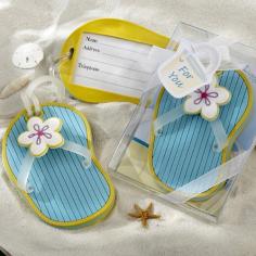 In a world of look-alike luggage, any distinctive marking on a suitcase makes it easier to identify when you reach your port of call, saving time to enjoy your travels. Why not give your guests the precious gift of time with this unique and playful wedding favor? The Flip-Flop Luggage Tag is a meaningful memento they're sure to take everywhere they go, along with the wonderful memories you've given them. This ever-popular summer sandal looks and feels like a miniature version of the flip-flops you wear! The insole is a soft, sky blue with bright-yellow trim and "traction grooves," just like the real thing. Clear toe straps meet at the top, where a fanciful, white flower with purple and yellow accents lends a touch of style. Flip the flip-flop over to find a yellow sole that holds the information card. A thin, clear, stretchable strap secures the tag to the luggage. Designed for a destination wedding, the clear gift box displays the lovely image of a sandy shore, a deep-blue sea, white