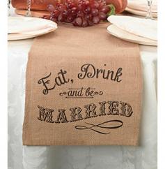 Web exclusive! This burlap table runner is a fun and stylish way to incorporate a rustic ambiance at your reception. Enhance reception tables and elicit a few giggles from guests with the Lillian Rose Burlap Table Runner. The words "Eat, Drink and be Married" are printed on both ends, bringing a touch of rural charm to any wedding celebration. With its natural look and long length, this burlap table runner is a fabulous choice for your special day. Brown 84" x 10" Burlap Imported