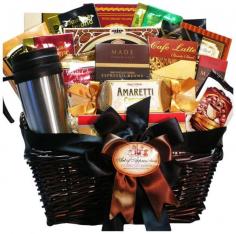 Your coffee connoisseur will truly appreciate this handsome gourmet gift basket filled with everything caffeine paired with great gourmet go-togethers to nibble, dunk and savor. After the goodies are gone, the dark stained wicker basket makes handy storage or decor in any office, den or home. Set includes: Travel coffee mug with lid, gourmet chocolate chip cookies, Bali's Best Espresso candy, mocha drink mix, Dolcettos Tiramisu pastry cookies, Torani almond hazelnut biscotti, Premium Columbian coffee, butterscotch-flavored coffee, Jamocha almond fudge coffee, mocha hazelnut java wafer cookie, white chocolate Amaretto wafer cookie, espresso glazed roasted almonds, La Patiserie crepes cookies, Barista Blend cafe latte mix, chocolate-covered espresso beans, Java bon cappuccino candy, Italian Ameretti cookies, chocolate espresso bar Materials: Dark stained wicker basket, ribbon accents Dimensions: 15 inches x 10 inches x 10 inches Weight: 5 pounds Due to the perishable nature of food items, returns are not accepted by state law.