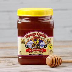 A beekeeper's favorite, the Topanga Quality Wildflower Raw Unfiltered Honey is made at a family farm located in Ventura County, California. Darker in color and slightly richer, this honey will taste wonderfully with tea, biscuits, yogurt, even sauces and marinades. State of Origin: California Set includes: One (1) 3-pound wildflower honey jar Brand: Topanga Quality Honey Container: Plastic jar Weight: 3 pounds This product is part of our 'Farmers Market'. Due to the perishable nature of this artisanal product, returns cannot be accepted. This Purveyor's Story: Bennett's Honey Farm was started in the late 1970's by Red and Anne Bennett, when a swarm of bees landed in their yard. Deciding then, to allow the bees to stay and prosper, the bees produced a delicious local honey from the surrounding land. Later they acquired the Topanga Quality Honey label and the business moved to Fillmore, CA where it continues to produce a variety of distinct and flavorful honeys in their 100-percent solar-powered, kosher and organic facility. Through a unique process of gravity straining, the honey retains more flavor and nutrients that is drawn from the local flora. After retiring in 2011, the Bennetts sold their thriving business to long-time customers Chip and Taydee Vannoy who now employ many 3rd-generation beekeepers and workers from the surrounding communities to bring a high level of commitment and expertise to the business.