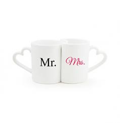 Start your mornings off right with our Mr. & Mrs. Coffee Mug Set. Crafted of ceramic stoneware and designed like a puzzle piece set, the heart shaped handled mugs feature a black Mr. and bright pink Mrs. across each of the coordinating coffee cups. Ideal vessels for hot and cold beverages, this adorable set fits together perfectly - just like the two of you! Dishwasher and microwave safe. Details: Size: Mugs hold up to 10 ounces. Materials: Ceramic stoneware For personalization items please submit your request to personalizeinfo@alihamsgiftoutlet.com with engraving details.